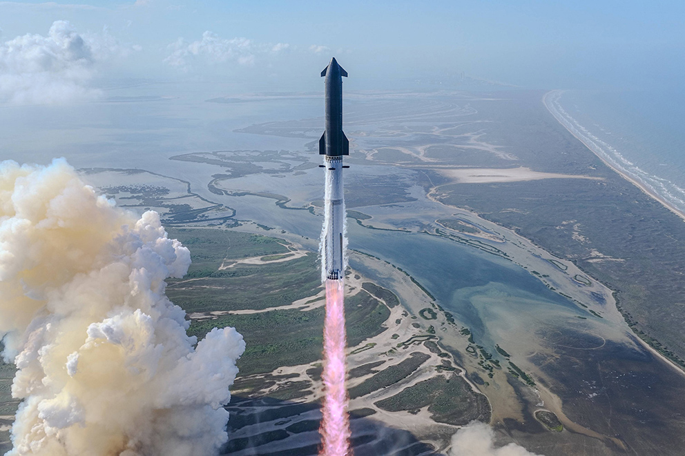 SpaceX-Starship-Rakete steigt mit Feuerstrahl über einer Küstenlandschaft auf – Symbolbild zur SpaceX-Aktie